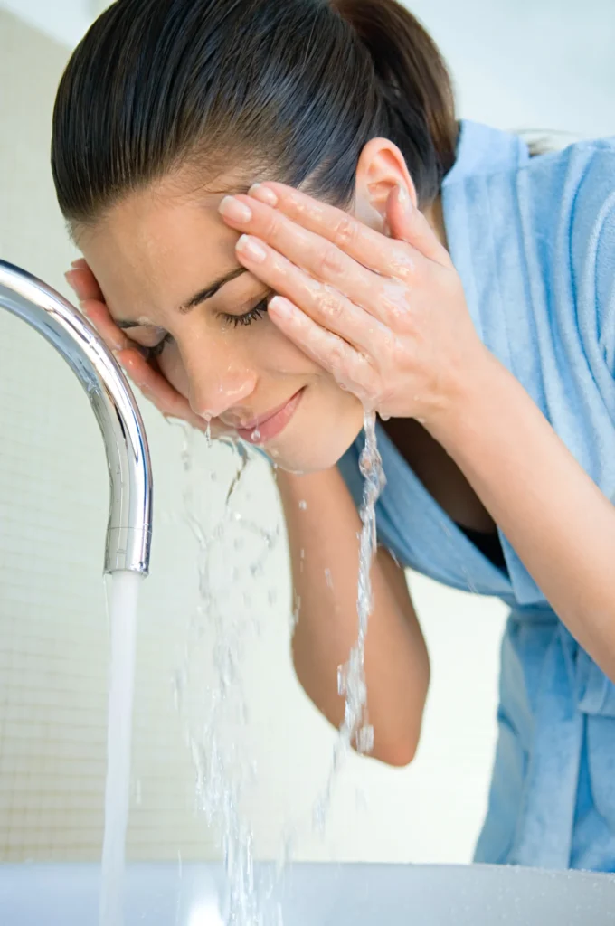 young-woman-refreshing-with-a-splash-of-water